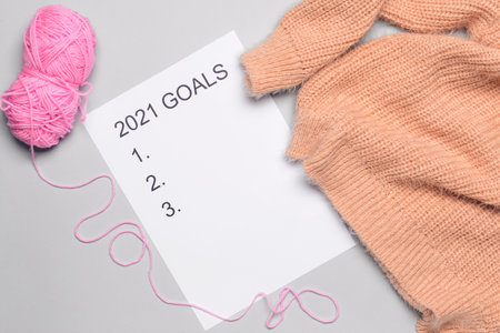 Empty to do list on 2021 year with knitting yarn and sweater on light backgroundの写真素材