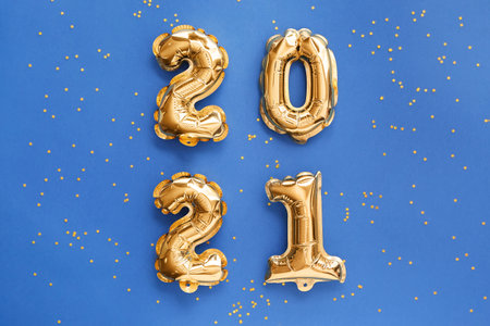 Balloons in shape of figure 2021 on color background. New Year celebrationの写真素材
