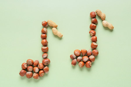 Music notes made of nuts on color backgroundの写真素材