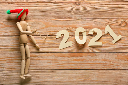 Human mannequin and figure 2021 on wooden background