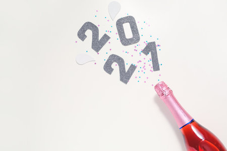 Christmas composition with bottle of champagne on white backgroundの写真素材