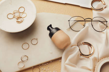 Bottle of makeup foundation and accessories on color backgroundの写真素材