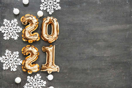 Figure 2020 made of balloons and Christmas decor on dark background