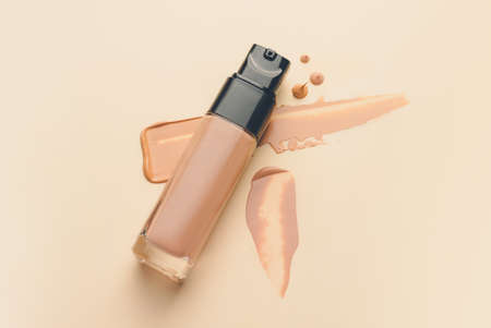 Bottle of makeup foundation and samples on color backgroundの写真素材