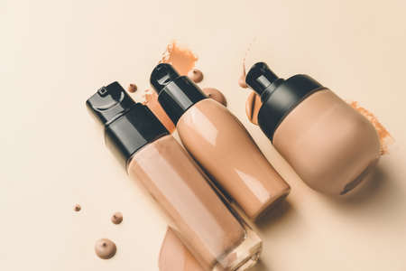 Bottles of makeup foundation and samples on color backgroundの写真素材
