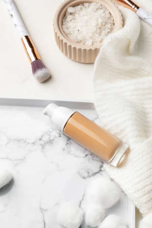 Bottle of makeup foundation on light background