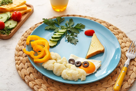 Creative breakfast for children with egg on light backgroundの写真素材