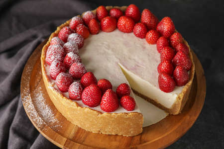 Tasty cheesecake with strawberry on dark backgroundの写真素材