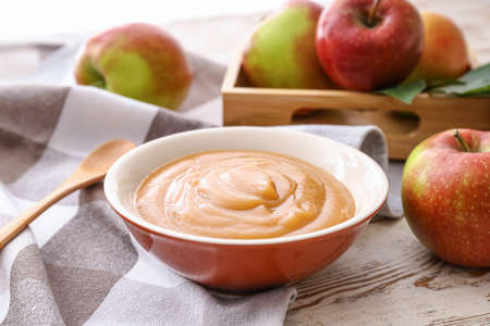 Bowl with sweet apple jam on wooden backgroundの写真素材