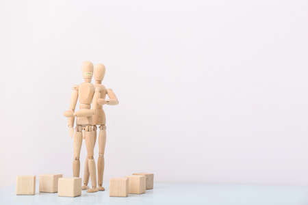 Wooden mannequins on light background. Concept of violenceの写真素材