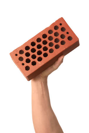 Brown brick in male hand on white backgroundの写真素材
