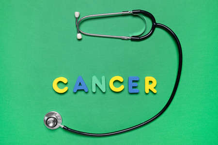 Stethoscope with word CANCER on color backgroundの写真素材