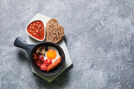 Traditional English breakfast with fried eggs on gray backgroundの写真素材