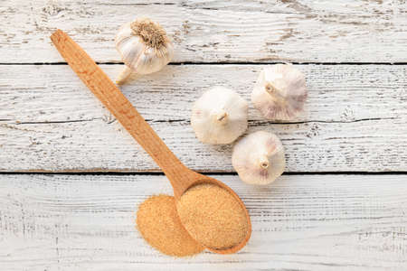 Spoon with aromatic powdered garlic on tableの写真素材