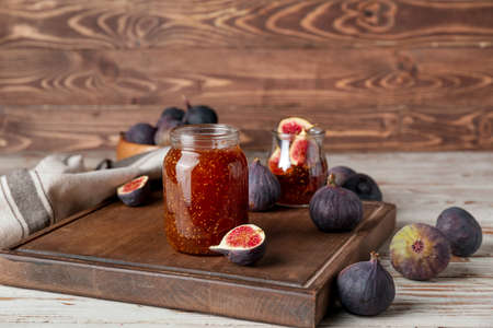 Jar of sweet fig jam on wooden tableの写真素材