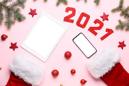 New year composition with modern devices on color backgroundの写真素材