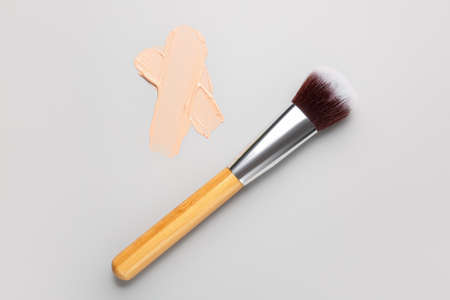 Sample of makeup foundation and brush on light backgroundの写真素材