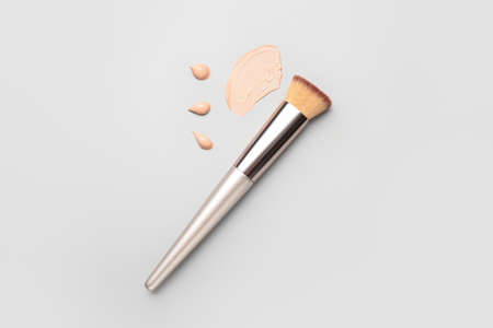 Samples of makeup foundation and brush on light backgroundの写真素材