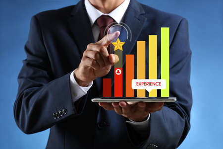 Businessman giving rating to new computer application on color background