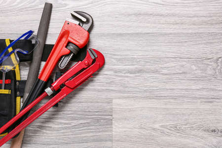 Set of construction tools on light wooden background