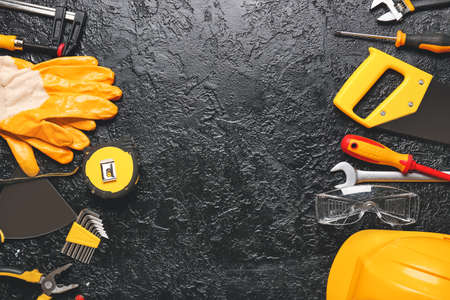 Set of construction tools on dark background