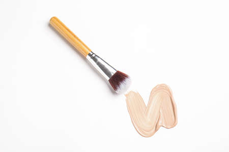 Sample of makeup foundation and brush on white backgroundの写真素材