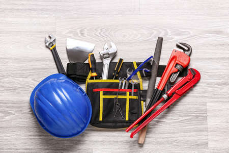 Set of construction tools on light wooden background