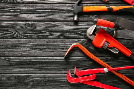 Set of construction tools on dark wooden background