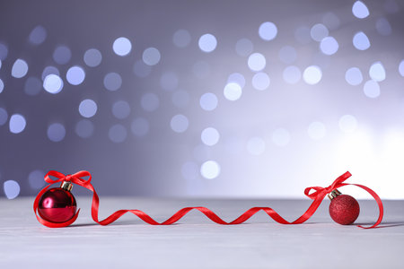 Christmas decor on table against blurred lightsの写真素材