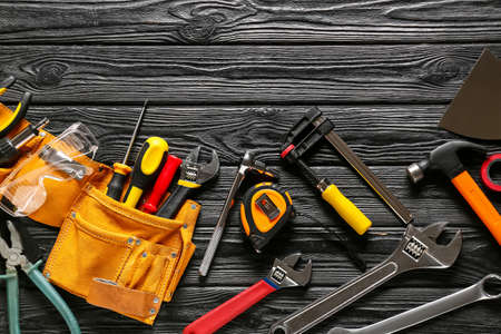 Set of construction tools on dark wooden background