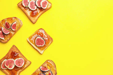 Tasty sandwiches with sweet fig jam on color background