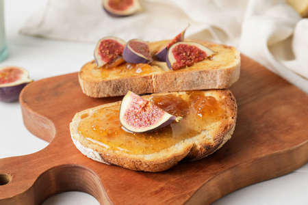 Tasty sandwiches with sweet fig jam on table, closeupの写真素材