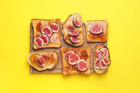 Tasty sandwiches with sweet fig jam on color backgroundの写真素材