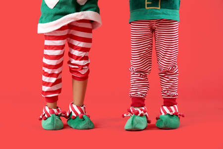 Cute little elves on color background