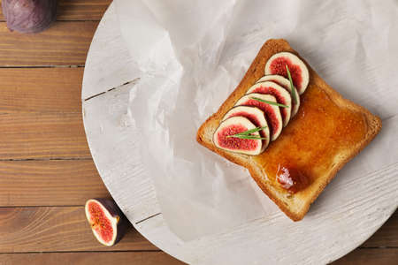Tasty sandwich with sweet fig jam on tableの写真素材