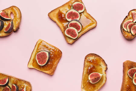 Tasty sandwiches with sweet fig jam on color backgroundの写真素材
