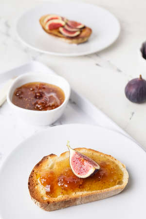 Plate with tasty sandwich with fig jam on tableの写真素材
