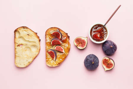 Tasty sandwiches with sweet fig jam on color backgroundの写真素材
