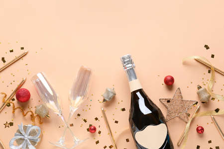 New Year composition with bottle of champagne on color backgroundの写真素材