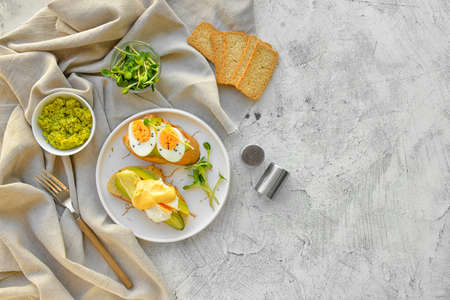 Plate with tasty sandwiches on gray background