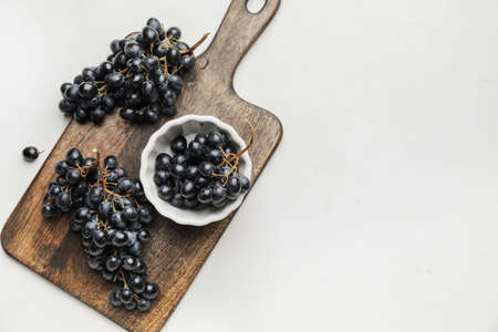 Composition with sweet ripe grapes on tableの写真素材