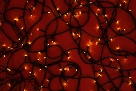 Glowing Christmas lights on color background