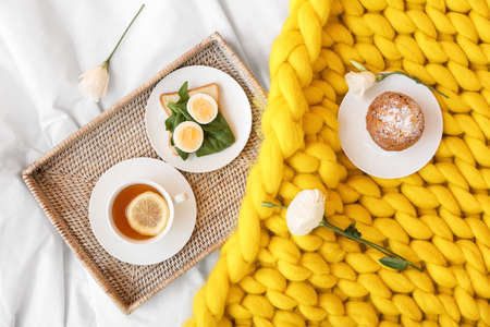 Tray with tasty breakfast on bedの写真素材