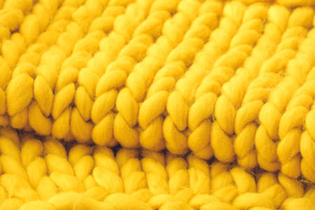 Yellow knitted plaid as backgroundの写真素材