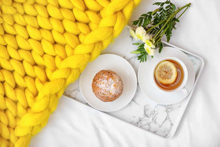 Tray with tasty breakfast on bedの写真素材