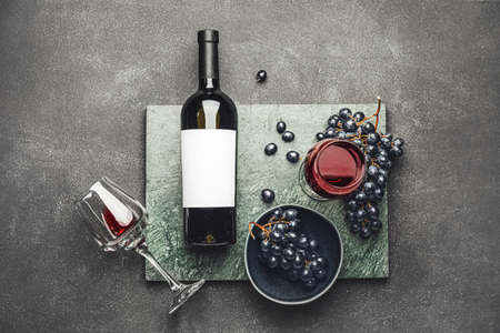 Tasty red wine with fresh grapes on dark backgroundの写真素材