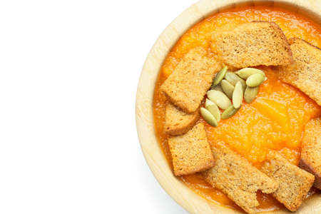 Tasty pumpkin cream soup in bowl on white backgroundの写真素材
