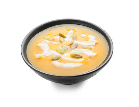 Tasty pumpkin cream soup in bowl on white backgroundの写真素材