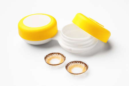 Container with contact lenses on white backgroundの写真素材