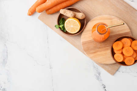 Bottle of carrot juice on light backgroundの写真素材